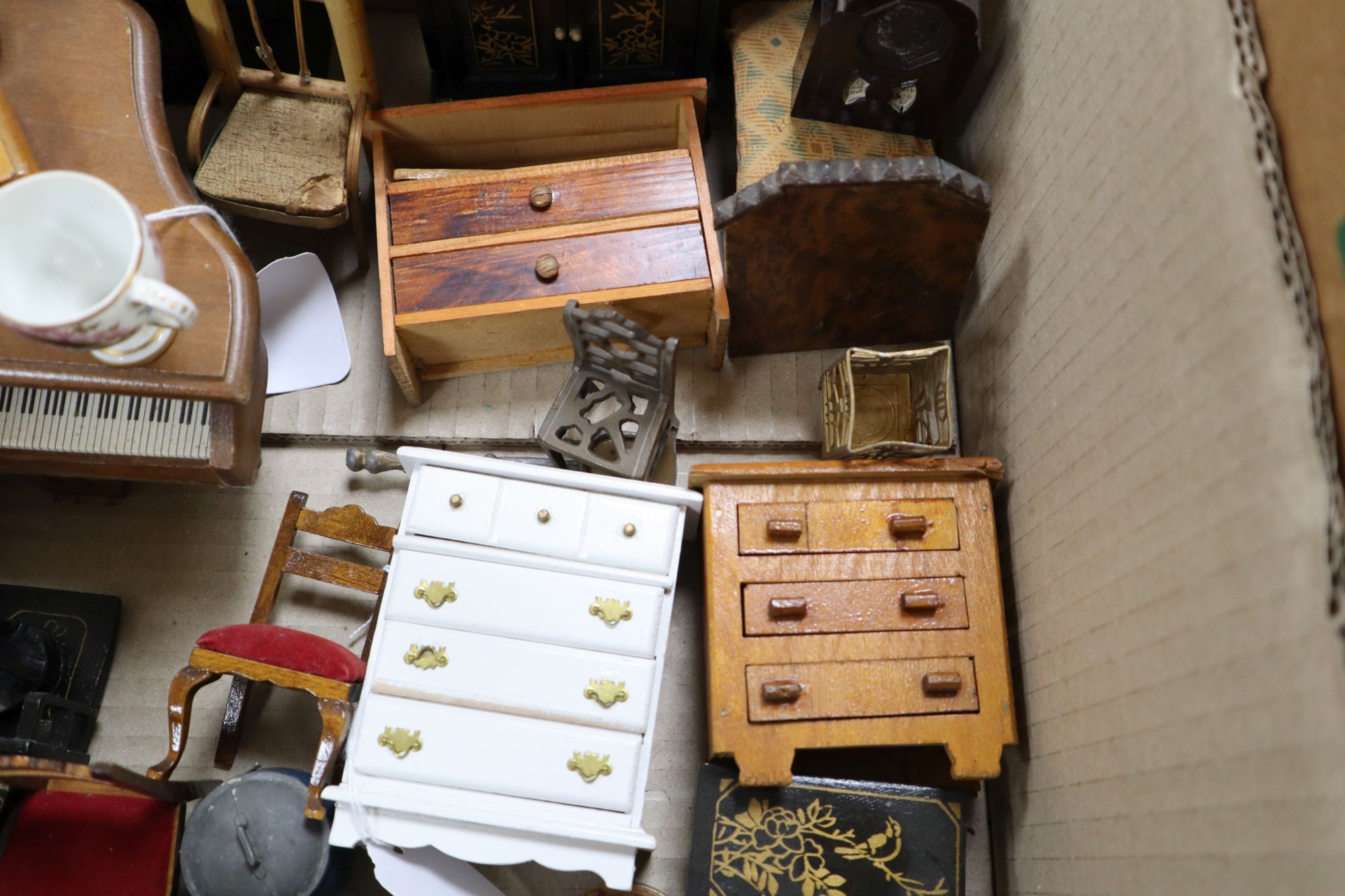 A collection of dolls and dolls house furniture displayed in room settings in a pine cupboard, width 84cm, depth 36cm, height 132cm